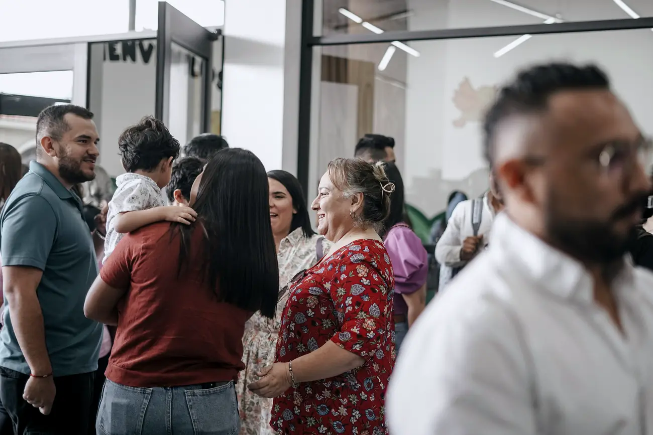 People talking together at a busy community centre