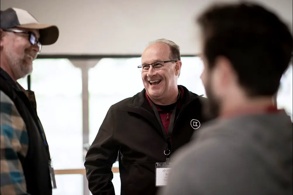 People talking and laughing together at a stakeholder event