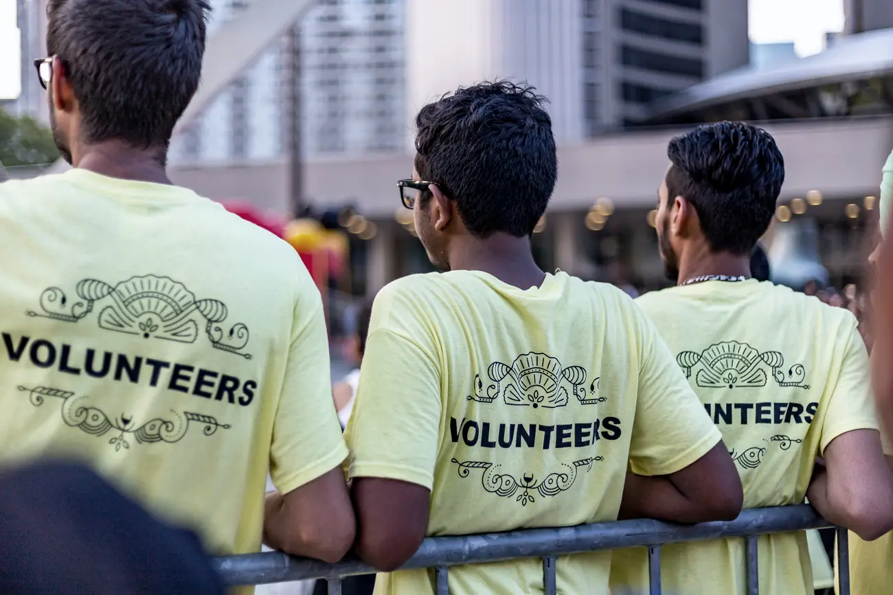 Volunteers in branded shirts at a city community event